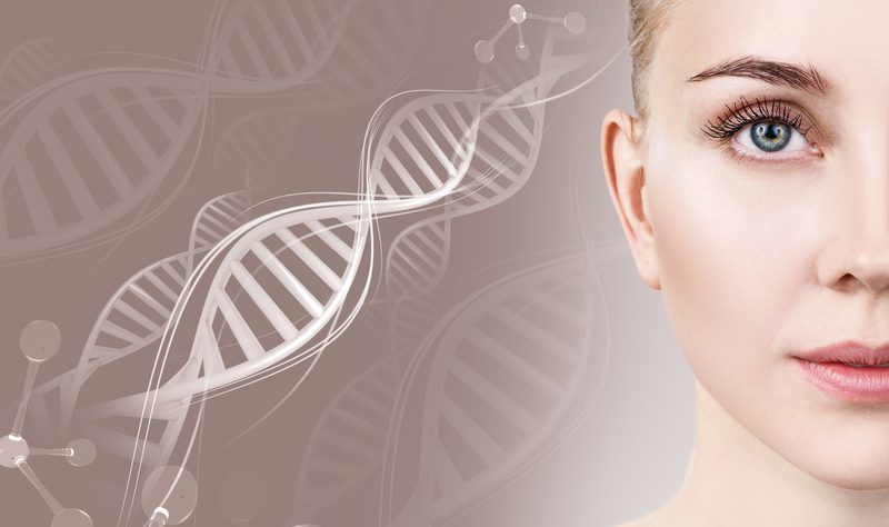 A woman with her eyes closed and a dna strand in the background.