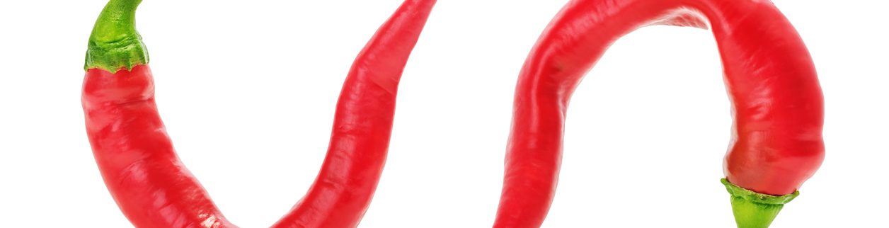 Two red peppers are shown on a white background.