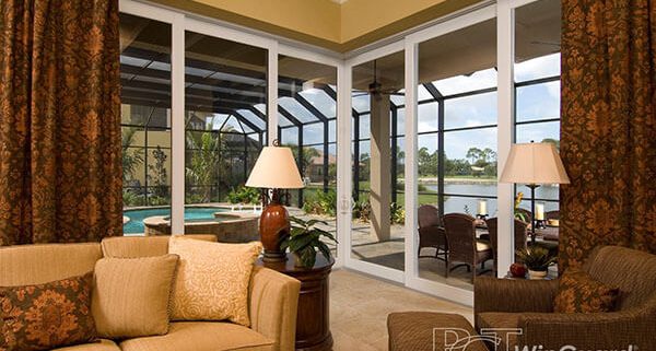 A living room with large windows and couches.