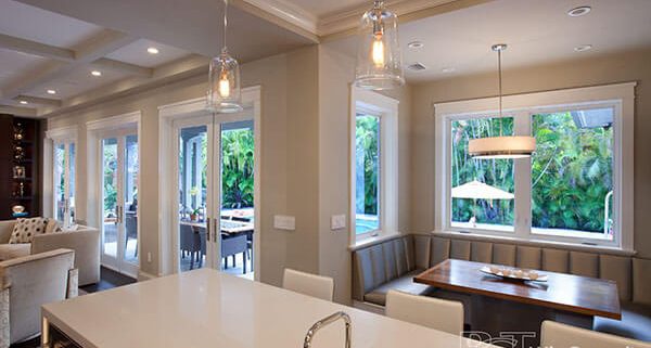 A kitchen with a dining room and breakfast nook.