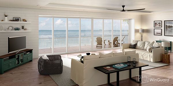 A living room with large windows overlooking the ocean.