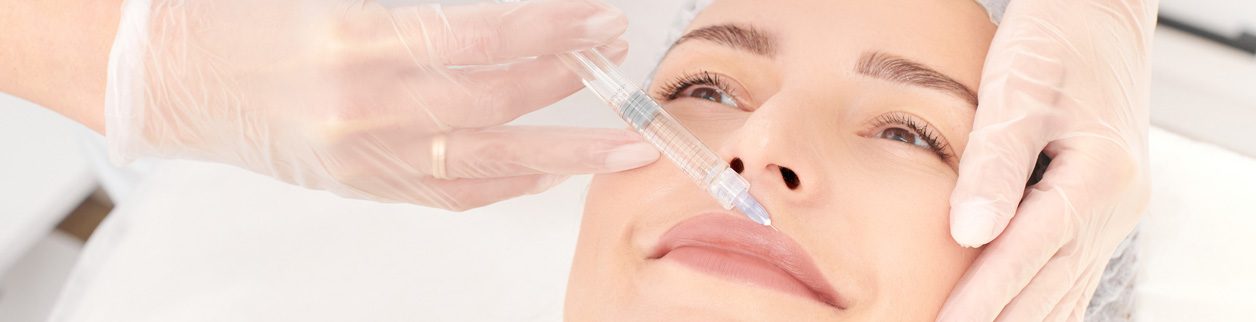 A woman is getting her lips filled with botox.