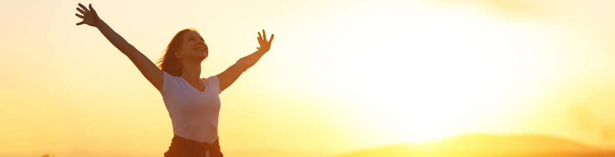 A person reaching up into the sky to catch something.