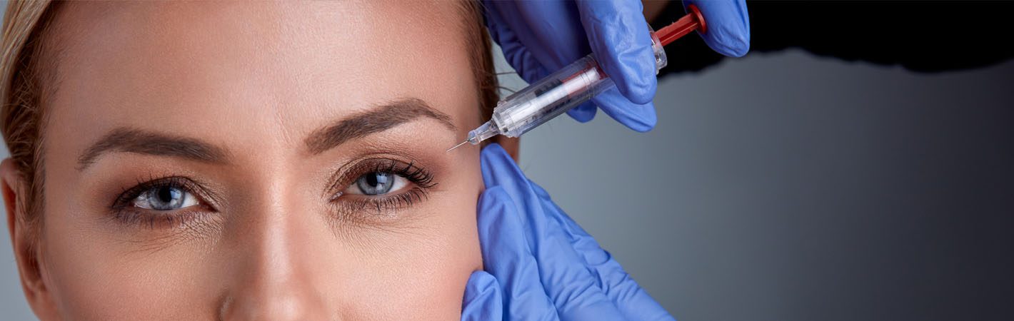 A woman getting an injection into her eye. A woman getting an injection into her eye.